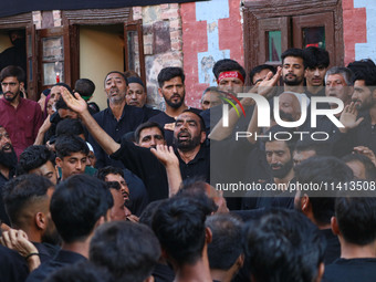 Kashmiri Shiite Muslim mourners are participating in a Muharram procession on the ninth day of Ashura in the interiors of Dal Lake in Srinag...