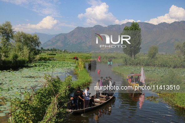 Kashmiri Shiite Muslim mourners are participating in a Muharram procession on boats on the ninth day of Ashura in the interiors of Dal Lake...