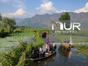 Kashmiri Shiite Muslim mourners are participating in a Muharram procession on boats on the ninth day of Ashura in the interiors of Dal Lake...