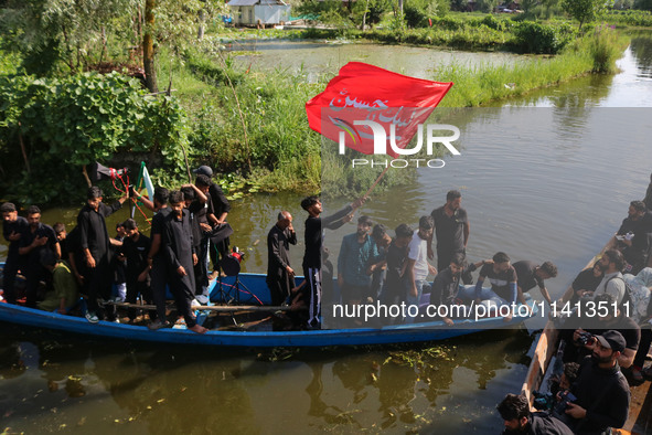 Kashmiri Shiite Muslim mourners are participating in a Muharram procession on boats on the ninth day of Ashura in the interiors of Dal Lake...