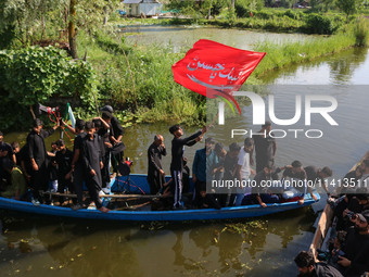 Kashmiri Shiite Muslim mourners are participating in a Muharram procession on boats on the ninth day of Ashura in the interiors of Dal Lake...