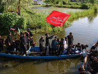 Kashmiri Shiite Muslim mourners are participating in a Muharram procession on boats on the ninth day of Ashura in the interiors of Dal Lake...