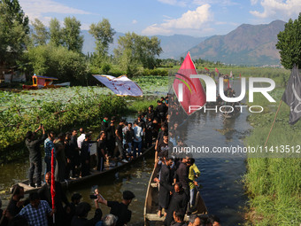 Kashmiri Shiite Muslim mourners are participating in a Muharram procession on boats on the ninth day of Ashura in the interiors of Dal Lake...