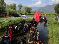 Kashmiri Shiite Muslim mourners are participating in a Muharram procession on boats on the ninth day of Ashura in the interiors of Dal Lake...