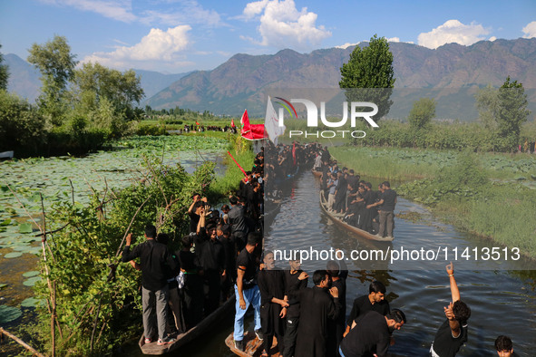 Kashmiri Shiite Muslim mourners are participating in a Muharram procession on boats on the ninth day of Ashura in the interiors of Dal Lake...