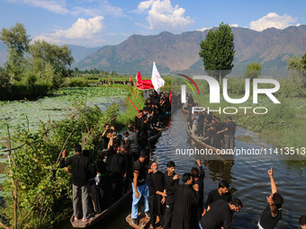 Kashmiri Shiite Muslim mourners are participating in a Muharram procession on boats on the ninth day of Ashura in the interiors of Dal Lake...