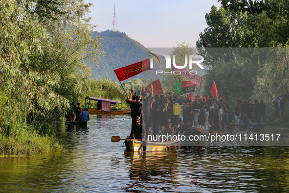 Kashmiri Shiite Muslim mourners are participating in a Muharram procession on boats on the ninth day of Ashura in the interiors of Dal Lake...