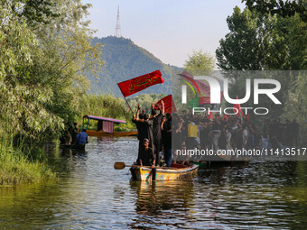 Kashmiri Shiite Muslim mourners are participating in a Muharram procession on boats on the ninth day of Ashura in the interiors of Dal Lake...