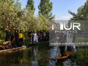 Kashmiri Shiite Muslim mourners are participating in a Muharram procession on boats on the ninth day of Ashura in the interiors of Dal Lake...