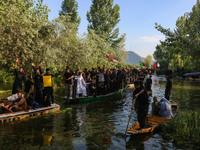 Kashmiri Shiite Muslim mourners are participating in a Muharram procession on boats on the ninth day of Ashura in the interiors of Dal Lake...