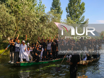 Kashmiri Shiite Muslim mourners are participating in a Muharram procession on boats on the ninth day of Ashura in the interiors of Dal Lake...