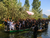 Kashmiri Shiite Muslim mourners are participating in a Muharram procession on boats on the ninth day of Ashura in the interiors of Dal Lake...