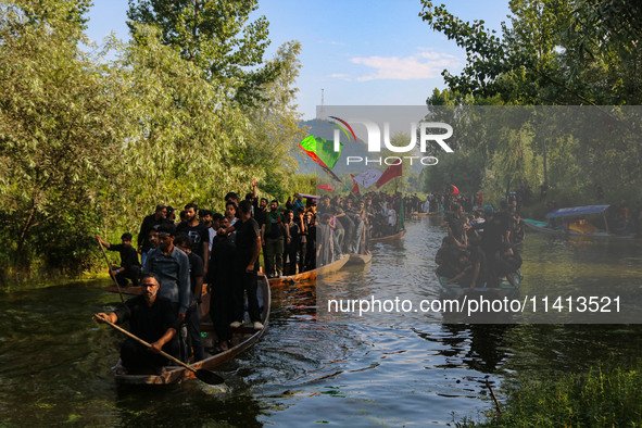 Kashmiri Shiite Muslim mourners are participating in a Muharram procession on boats on the ninth day of Ashura in the interiors of Dal Lake...