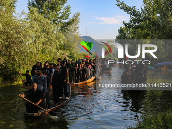 Kashmiri Shiite Muslim mourners are participating in a Muharram procession on boats on the ninth day of Ashura in the interiors of Dal Lake...