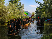 Kashmiri Shiite Muslim mourners are participating in a Muharram procession on boats on the ninth day of Ashura in the interiors of Dal Lake...