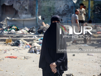 Palestinians are inspecting a UN school sheltering displaced people, following an Israeli strike, amid the Israel-Hamas conflict, in Nuseira...