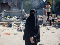 Palestinians are inspecting a UN school sheltering displaced people, following an Israeli strike, amid the Israel-Hamas conflict, in Nuseira...