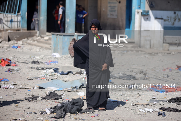 Palestinians are inspecting a UN school sheltering displaced people, following an Israeli strike, amid the Israel-Hamas conflict, in Nuseira...