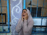 A displaced Palestinian woman is reacting at a UN school used as a shelter, following an Israeli strike, amid the Israel-Hamas conflict, in...