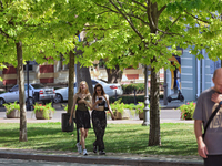 Two girls are walking along an alley on a hot summer day in Odesa, Ukraine, on July 13, 2024. NO USE RUSSIA. NO USE BELARUS. (