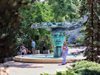 A woman is standing at the Beginning of Beginnings fountain in Greek Park on Prymorskyi Boulevard in Odesa, Ukraine, on July 13, 2024. NO US...