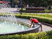 A boy is playing by a fountain on a hot summer day in Odesa, Ukraine, on July 13, 2024. NO USE RUSSIA. NO USE BELARUS. (