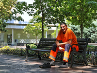 A smiling municipal worker is sitting on the bench in the shadow on a hot summer day in Odesa, Ukraine, on July 13, 2024. NO USE RUSSIA. NO...