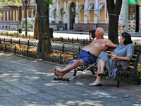 An elderly man and woman are sitting on the bench in the shadow on a hot summer day in Odesa, Ukraine, on July 13, 2024. NO USE RUSSIA. NO U...