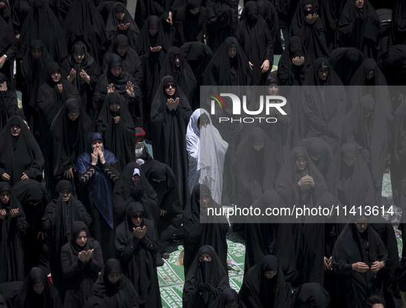 Veiled Iraqi women living in Iran are praying during a religious festival to commemorate Ashura, in Dolatabad neighborhood in southern Tehra...