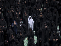 Veiled Iraqi women living in Iran are praying during a religious festival to commemorate Ashura, in Dolatabad neighborhood in southern Tehra...