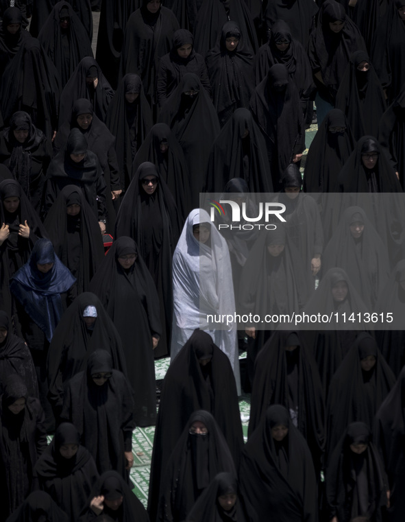 Veiled Iraqi women living in Iran are praying during a religious festival to commemorate Ashura, in Dolatabad neighborhood in southern Tehra...