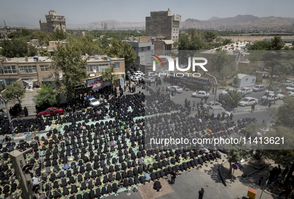 Iraqi men and women living in Iran are praying during a religious festival to commemorate Ashura in the Dolatabad neighborhood in southern T...