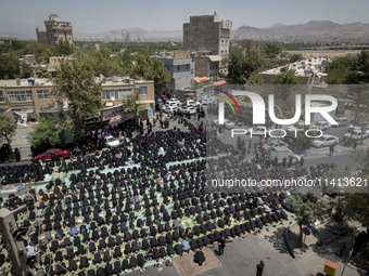 Iraqi men and women living in Iran are praying during a religious festival to commemorate Ashura in the Dolatabad neighborhood in southern T...