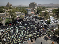 Iraqi men and women living in Iran are praying during a religious festival to commemorate Ashura in the Dolatabad neighborhood in southern T...