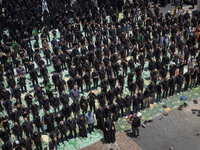 Iraqi men and women living in Iran are praying during a religious festival to commemorate Ashura in the Dolatabad neighborhood in southern T...