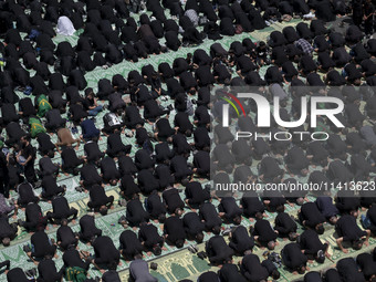 Iraqi men and women living in Iran are praying during a religious festival to commemorate Ashura in the Dolatabad neighborhood in southern T...