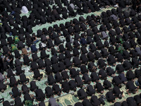 Iraqi men and women living in Iran are praying during a religious festival to commemorate Ashura in the Dolatabad neighborhood in southern T...