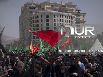 Iraqi men living in Iran are waving religious flags while participating in a religious festival to commemorate Ashura in the Dolatabad neigh...