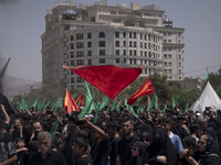 Iraqi men living in Iran are waving religious flags while participating in a religious festival to commemorate Ashura in the Dolatabad neigh...