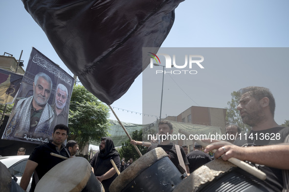 Iraqi men living in Iran are playing traditional musical instruments while participating in a religious festival to commemorate Ashura in th...