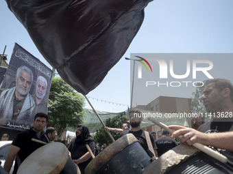 Iraqi men living in Iran are playing traditional musical instruments while participating in a religious festival to commemorate Ashura in th...