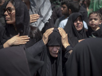 An Iraqi woman living in Iran is beating herself while participating in a religious festival to commemorate Ashura in the Dolatabad neighbor...