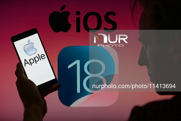 The Apple logo is being displayed on a smartphone with Apple iOS 18 visible in the background, in this photo illustration in Brussels, Belgi...