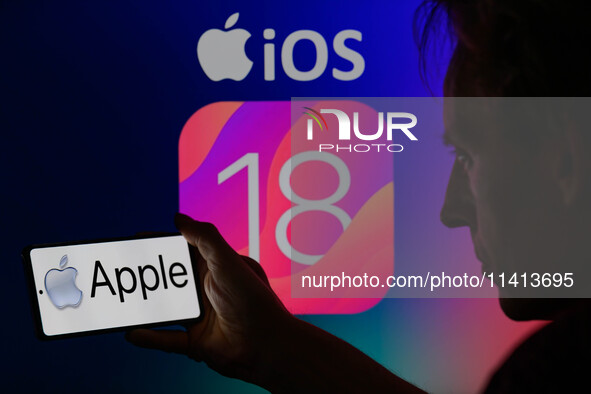 The Apple logo is being displayed on a smartphone with Apple iOS 18 visible in the background, in this photo illustration in Brussels, Belgi...