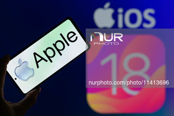 The Apple logo is being displayed on a smartphone with Apple iOS 18 visible in the background, in this photo illustration in Brussels, Belgi...