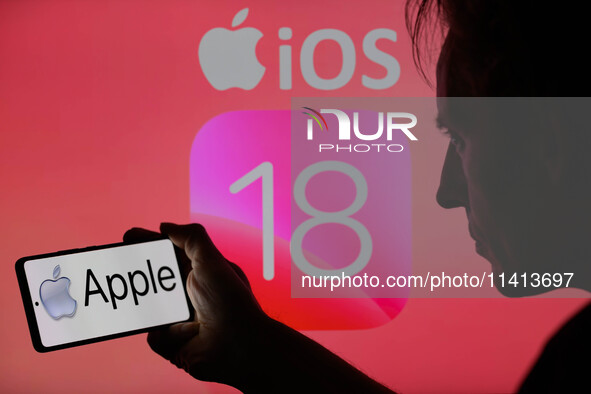 The Apple logo is being displayed on a smartphone with Apple iOS 18 visible in the background, in this photo illustration in Brussels, Belgi...