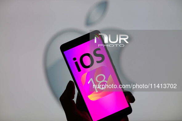 The Apple iOS 18 is being displayed on a smartphone with the Apple icon visible in the background, in this photo illustration in Brussels, B...