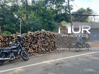 Wood is being harvested for use as firewood and is being stacked along the roadside in Punalur, Kerala, India, on April 04, 2024. (