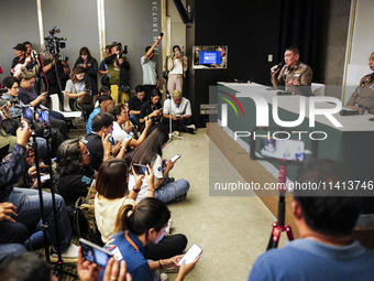 Metropolitan Police Bureau Commissioner Thiti Sangsawang is speaking as National Police Chief Torsak Sukvimol is looking on during a press c...