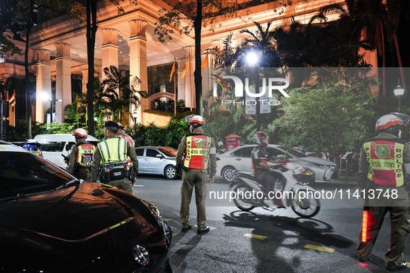 Police officers are standing outside the Grand Hyatt Erawan Hotel in Bangkok, Thailand, on July 16, 2024. Local news reports are saying that...